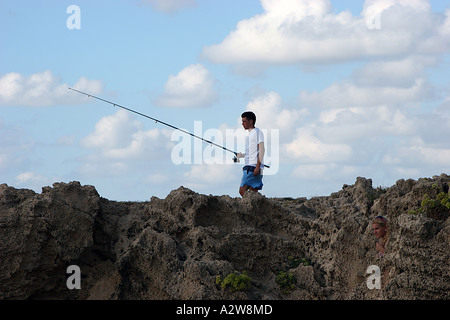 Fishing and relaxation on the rocky Habonim beach Israel Stock Photo