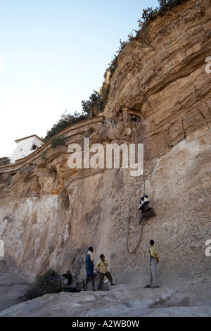 Monk or priest climbing ascending or descending rope to Debre Damo ...