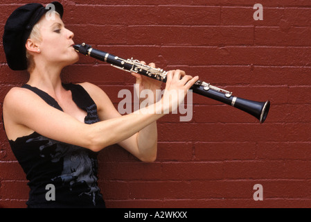 Young woman playing flute Stock Photo