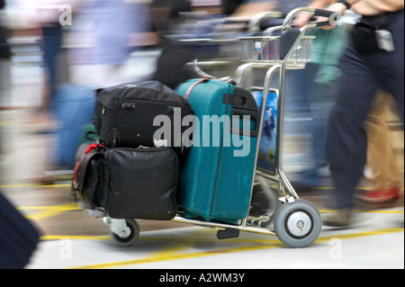 male passenger pushes luggage on trolley out of Reina Sofia Sur TFS South Airport Tenerife Canary Islands Spain Stock Photo
