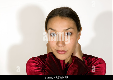 Young woman standing by wall, portrait Stock Photo