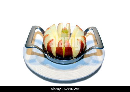 Sliced red apple on a white after being cut with a multi-edged slicer Stock Photo
