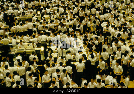 tokyo japan crowd of men at work on the trading floor of the japanese stock market Stock Photo