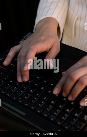 Young businesswoman using laptop, close up Stock Photo