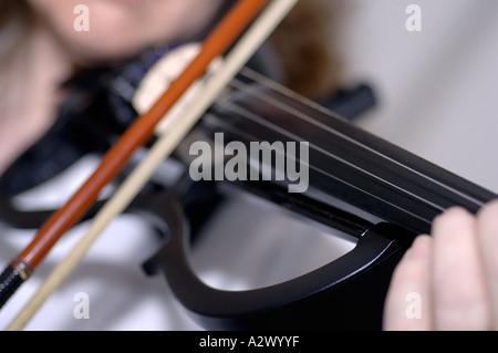 Woman playing electric violin Stock Photo