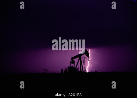 United States. California. Los Angeles region. Silhouette of oil well pumpjack with lightning. Stock Photo