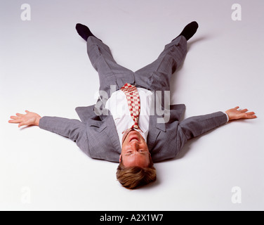 Studio image of young man lying on his back. Stock Photo