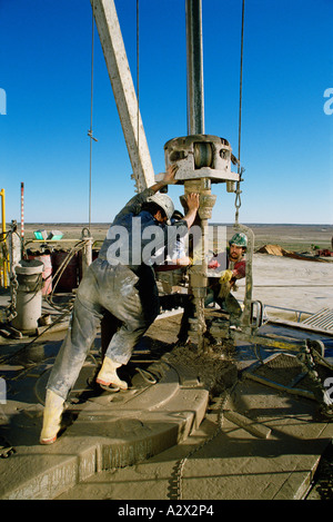 Australia. Industry. Oil extraction. Men operating drill at desert oil well. Stock Photo