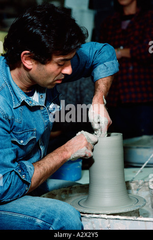 India. Uttar Pradesh. Man throwing a pot on potter's wheel. Stock Photo