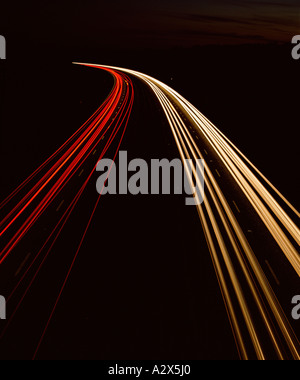 Light trails of two-way traffic on freeway at night. Stock Photo
