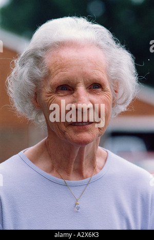 Portrait of old woman outside suburban house. Stock Photo