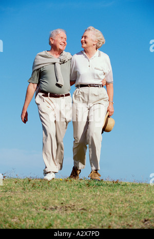Retired couple walking outdoors. Stock Photo
