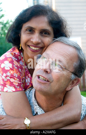 Lucky man enjoying a warm embrace from his wife age 60. St Paul Minnesota USA Stock Photo