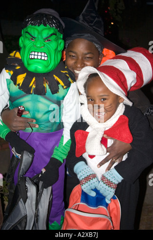 Halloween mom with her arms around her incredible Hulk and Cat in the Hat trick or treaters. St Paul Minnesota USA Stock Photo