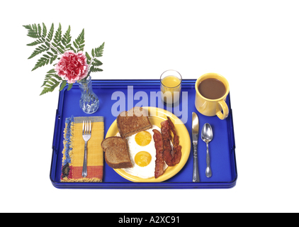 Breakfast in bed tray silhouetted on white background Stock Photo