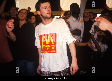 Legalise cannabis rally and march Brixton to Clapham Common London England. Man wearing T-shirt joke dancing in tent Calpham. 1980s HOMER SYKES Stock Photo