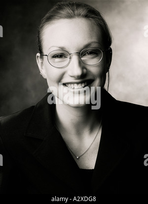 Indoor studio portrait of a young woman wearing spectacles. Stock Photo