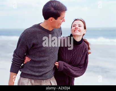 Happy couple outdoors by the sea. Stock Photo