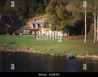 dh  RIVER TWEED BORDERS Boat on river bank holiday homes accomodation Stock Photo
