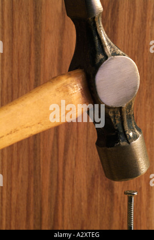 Hammer Hitting a Nail Over the Head Stock Photo