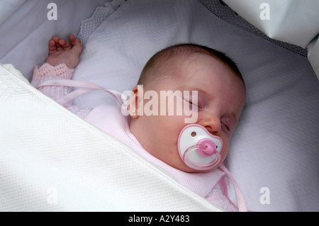 Sleeping baby girl with pierced ears Stock Photo