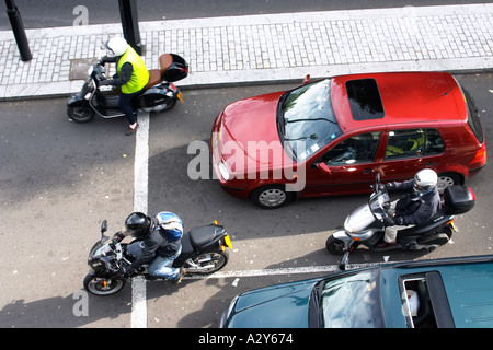 Motorbikes motorcycles cutting thorugh traffic in London UK united kingdom britain england Stock Photo