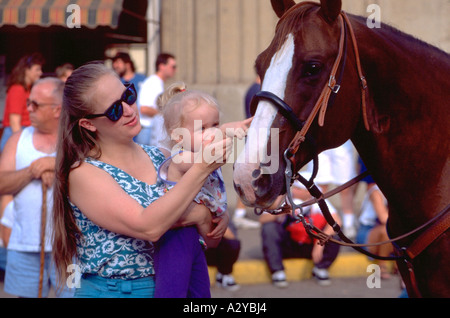 Mom helping daughter touch head of horse age 30 and 1. Minnesota State Fair St Paul Minnesota USA