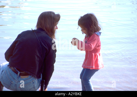 Asian daughter playing in Loring Pond age 25 and 3. Ben and Jerry's One World One Heart Festival Minneapolis Minnesota USA Stock Photo