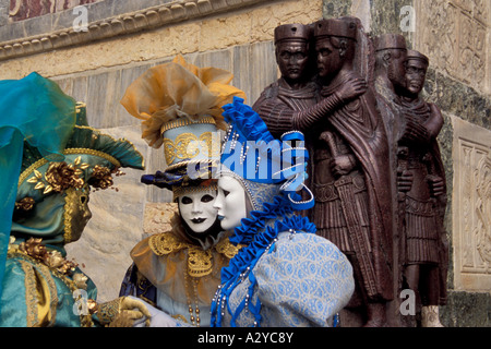 Gossip among Carnevale Revelers Echo the Statues in San Marco, Venice, Italy Stock Photo