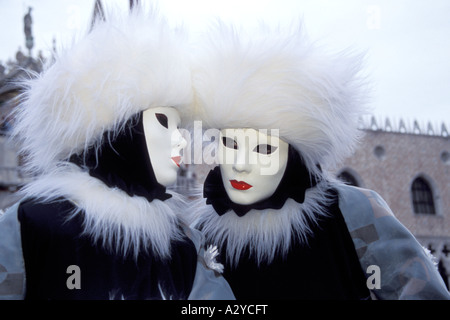 Carnevale Revelers in Black Velvet and White Fur Gossip in San Marco, Venice, Italy Stock Photo