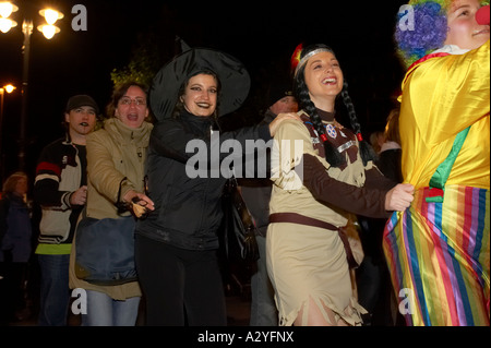 people in fancy dress do the conga dance through the crowd in guildhall square Halloween Derry Ireland Stock Photo