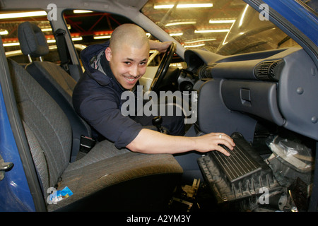 Motor Vehicle Technology NVQ male Student working on car in sixth form college workshop Stock Photo
