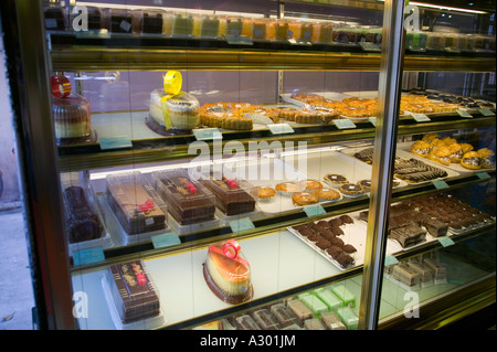 A display cabinet full of pastries in a fancy pastry shop in Banani Dhaka Bangladesh Stock Photo