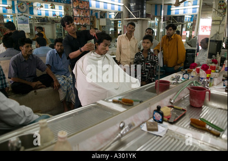 Customers getting haircuts at a barber shop in Dhaka Bangladesh Stock Photo