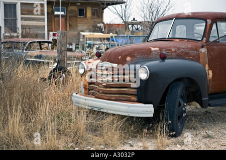 Old and disabled cars in front of the Marathon old railroad depot Texas Stock Photo