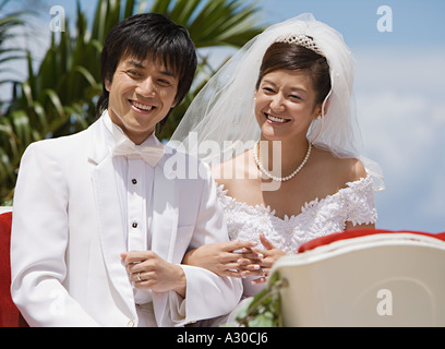 Newlyweds on horsedrawn carriage Stock Photo
