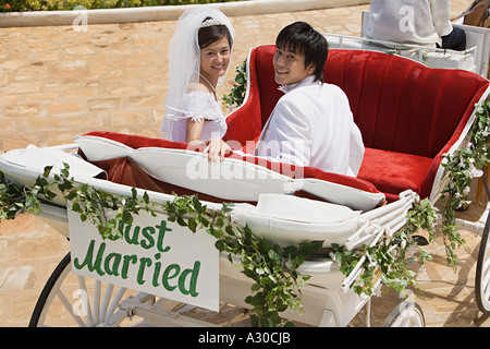 Bride and groom in horsedrawn carriage Stock Photo