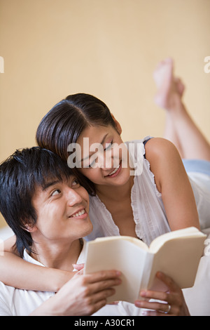 Couple reading book together Stock Photo