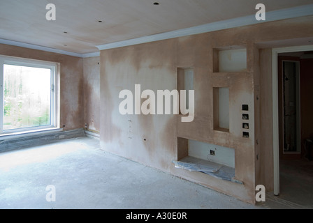 Makeover lounge, new lighting, new recesses, wet pink plaster drying out before decorating (for decorated view see Alamy A3WTPX) Stock Photo
