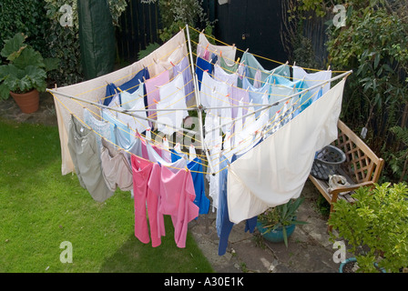 Looking down from above family clothes washing day hanging out to dry in summer sunshine on revolving rotating rotary clothes line in back garden UK Stock Photo