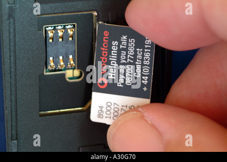 Vodafone company Sim card being inserted into mobile telephone England UK Stock Photo