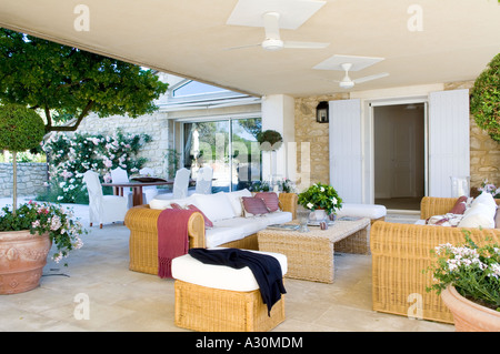 Terrace exterior with wicker furniture and ceiling fans Stock Photo