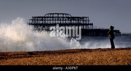 A stormy day on Brighton beach with the derelict West Pier in background. Stock Photo