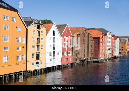 Wooden buildings on stilts along the Nidelva riverfront at Trondheim Norway Stock Photo