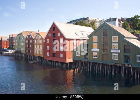 Wooden buildings on stilts along the Nidelva riverfront at Trondheim Norway Stock Photo
