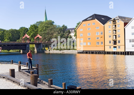 Wooden buildings on stilts along the Nidelva riverfront at Trondheim, Norway Stock Photo