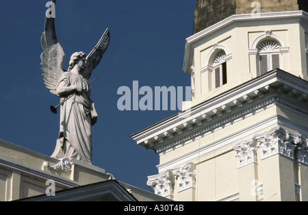 White angel statue holding a trumpet on top of an old building in Santiago, Cuba Stock Photo