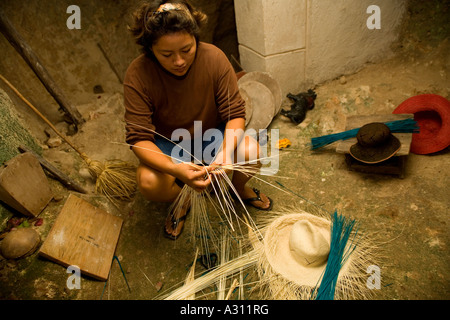 Woman braiding the famous panama straw hats in a traditional cave in Becal Mexico Stock Photo