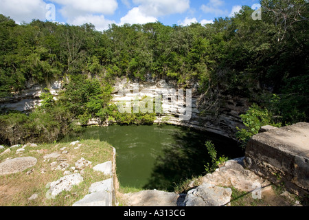 Cenote a sacred well used for human sacrifice at the ruined Mayan city of Chichen Itza in Mexico Stock Photo