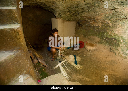 Woman braiding the famous panama straw hats in a traditional cave in Becal Mexico Stock Photo